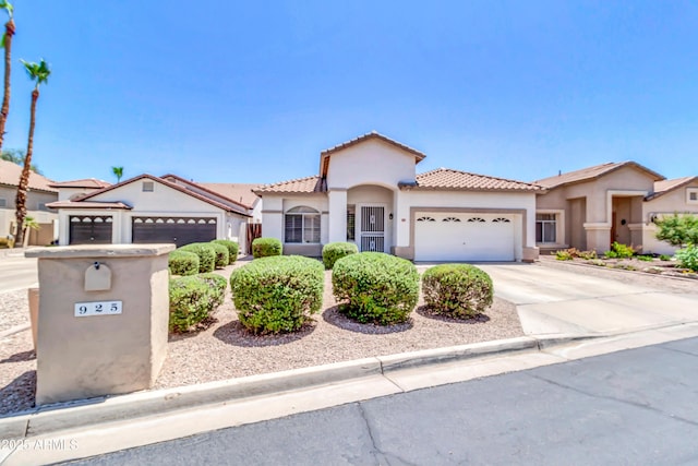 925 W San Marcos Dr, Chandler, AZ 85225 - mediterranean / spanish house featuring a garage, stucco siding, driveway, and a tiled roof