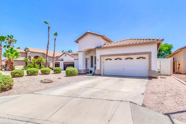 925 W San Marcos Dr, Chandler, AZ 85225 - mediterranean / spanish-style home with a garage, stucco siding, concrete driveway, a tile roof, and a gate