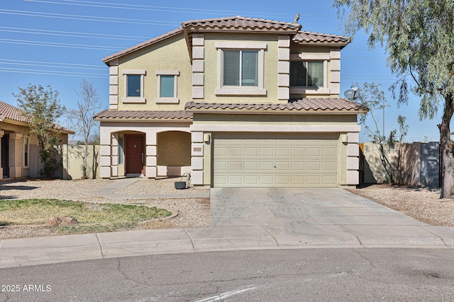 view of front facade featuring driveway, an attached garage, fence, and stucco siding