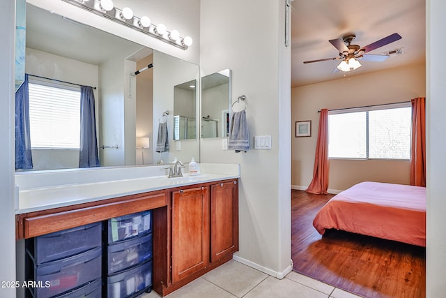 bathroom with tile patterned floors, visible vents, plenty of natural light, and ensuite bathroom