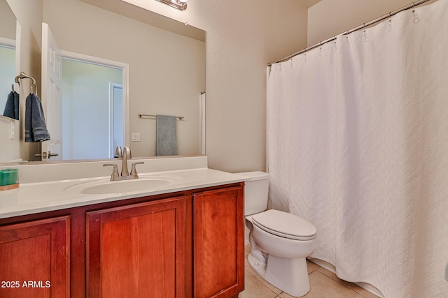 bathroom with toilet, vanity, and tile patterned floors