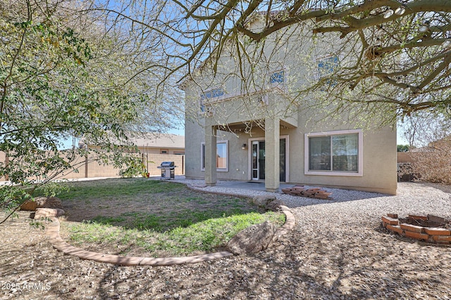 view of front of property featuring a patio, fence, and stucco siding