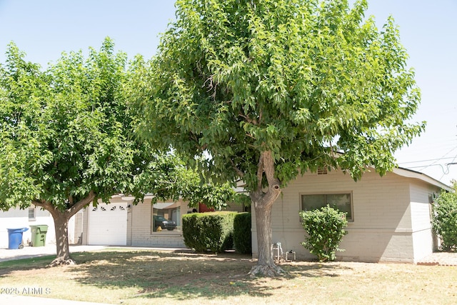 1412 W 7th Pl, Tempe, AZ 85281 - view of property hidden behind natural elements with brick siding and an attached garage
