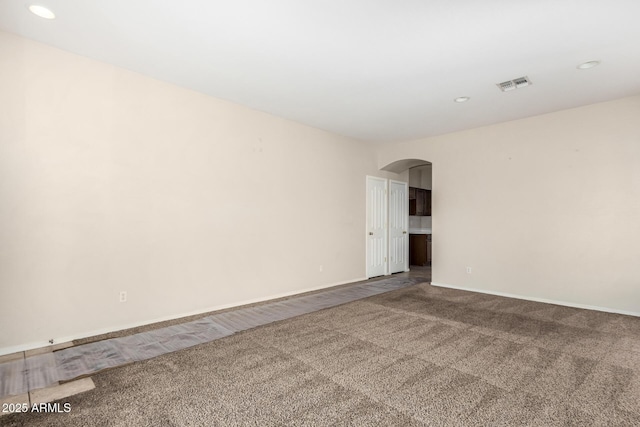 12814 W Indianola Ave, Avondale, AZ 85392 - carpeted empty room featuring visible vents, baseboards, recessed lighting, and arched walkways
