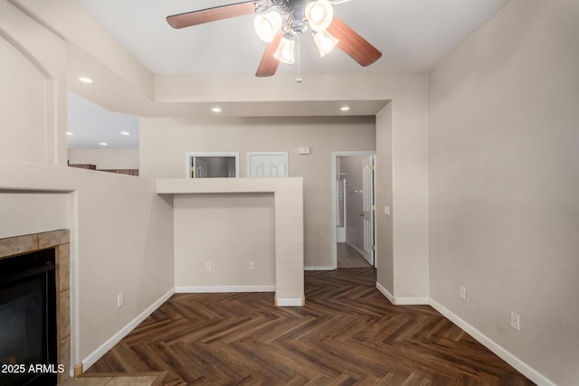 12814 W Indianola Ave, Avondale, AZ 85392 - unfurnished living room featuring recessed lighting, a tiled fireplace, baseboards, and ceiling fan