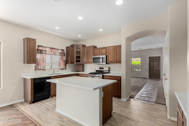 12814 W Indianola Ave, Avondale, AZ 85392 - kitchen featuring recessed lighting, light countertops, stainless steel appliances, arched walkways, and a sink