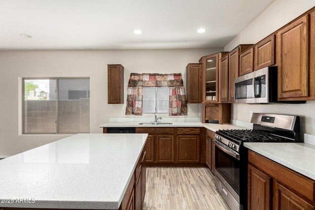 12814 W Indianola Ave, Avondale, AZ 85392 - kitchen with glass insert cabinets, light wood-type flooring, recessed lighting, appliances with stainless steel finishes, and a sink