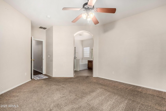 12814 W Indianola Ave, Avondale, AZ 85392 - interior space featuring arched walkways, ensuite bath, visible vents, carpet flooring, and baseboards