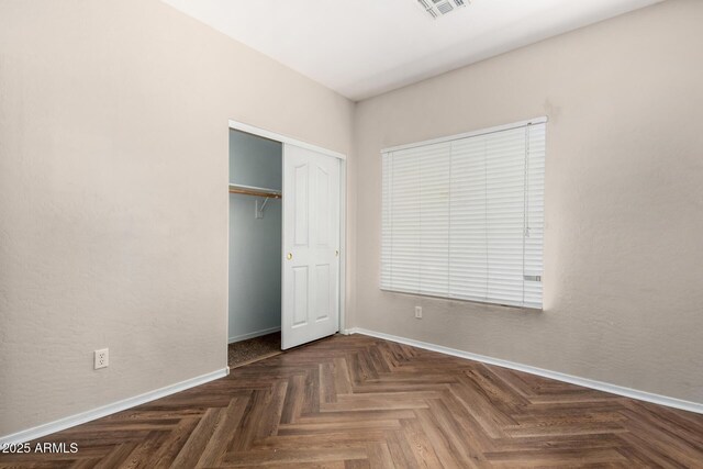 12814 W Indianola Ave, Avondale, AZ 85392 - unfurnished bedroom featuring a closet, baseboards, and visible vents