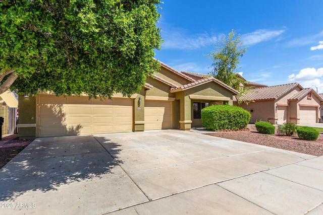 12814 W Indianola Ave, Avondale, AZ 85392 - mediterranean / spanish house with concrete driveway, stucco siding, a tiled roof, and an attached garage