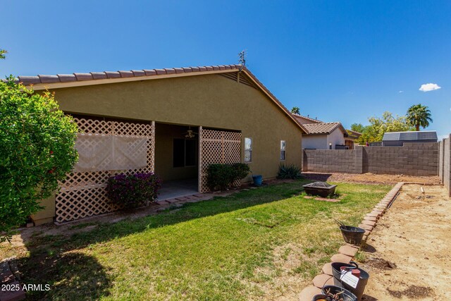 12814 W Indianola Ave, Avondale, AZ 85392 - back of property featuring a tiled roof, stucco siding, fence, and a lawn