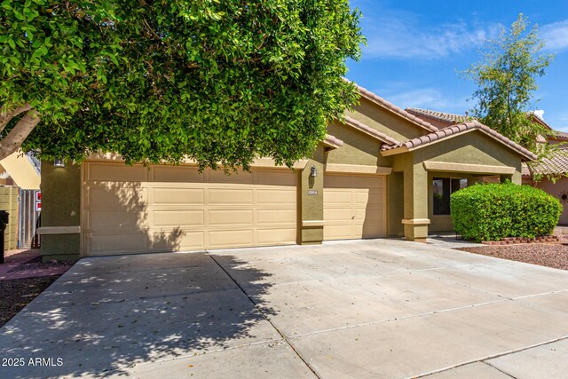 12814 W Indianola Ave, Avondale, AZ 85392 - view of front of house with concrete driveway, stucco siding, an attached garage, and a tile roof
