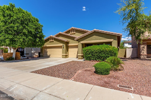 12814 W Indianola Ave, Avondale, AZ 85392 - view of front of house with driveway, stucco siding, an attached garage, and a tile roof