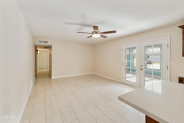 empty room with ceiling fan, baseboards, french doors, and visible vents