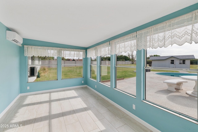 unfurnished sunroom with a wall mounted air conditioner