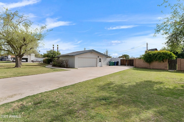 ranch-style home featuring driveway, fence, a garage, a front yard, and stucco siding