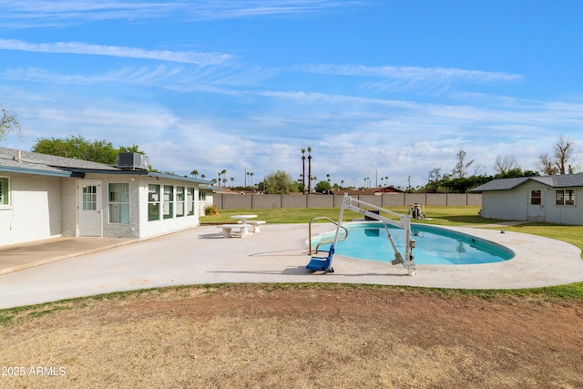 view of pool featuring central AC, an outdoor structure, fence, a patio, and a fenced in pool