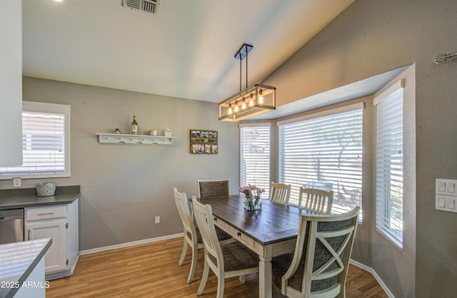 dining room featuring a wealth of natural light, visible vents, baseboards, and light wood-style floors