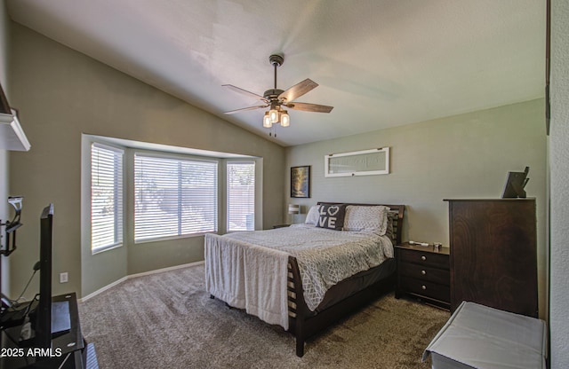 bedroom featuring baseboards, lofted ceiling, a ceiling fan, and dark carpet