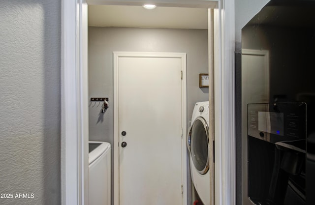 laundry area featuring washer / dryer and laundry area