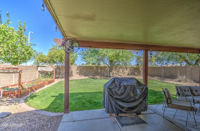 view of patio / terrace featuring a vegetable garden, a fenced backyard, and grilling area