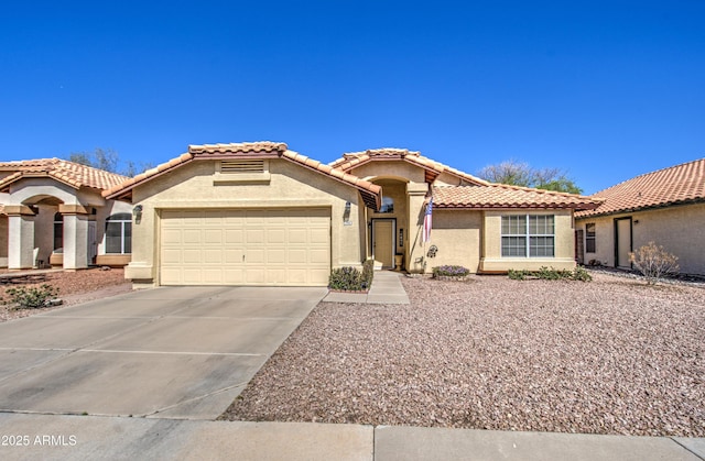 mediterranean / spanish-style house featuring stucco siding, a garage, driveway, and a tile roof