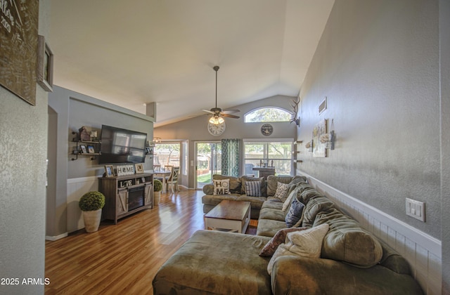 living room featuring high vaulted ceiling, wood finished floors, visible vents, and ceiling fan