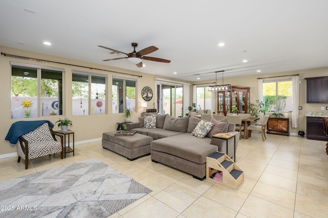 living area with light tile patterned floors, ceiling fan, recessed lighting, and plenty of natural light