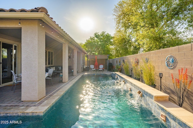 view of pool featuring a fenced backyard, a fenced in pool, and a patio