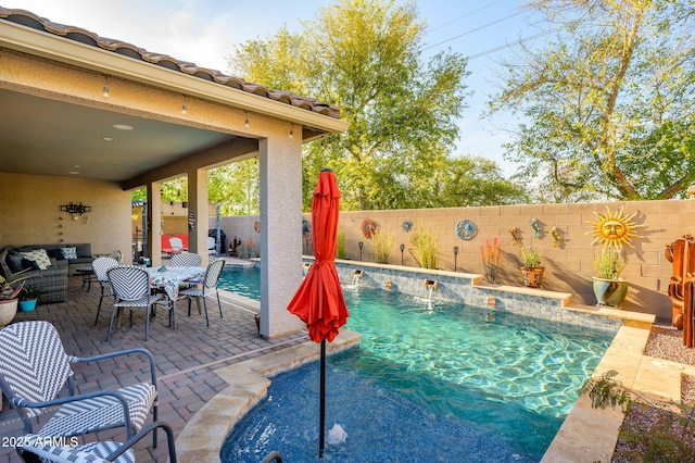 view of swimming pool with a fenced backyard, a fenced in pool, a patio area, and an outdoor hangout area