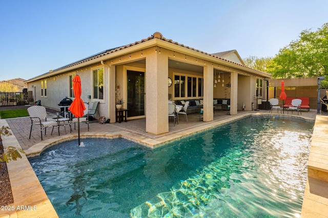 rear view of property featuring a fenced in pool, a patio, stucco siding, and fence