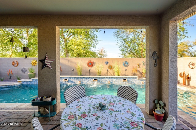exterior space with a fenced backyard, outdoor dining space, and a fenced in pool