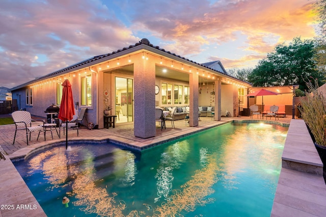 view of swimming pool with an outdoor hangout area, a fenced in pool, and a patio area