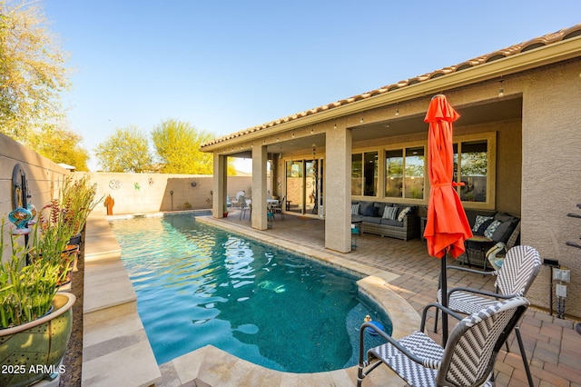 view of swimming pool with a patio area, a fenced backyard, an outdoor living space, and a fenced in pool