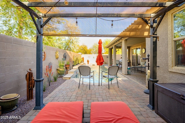 view of patio / terrace featuring a pergola and a fenced backyard