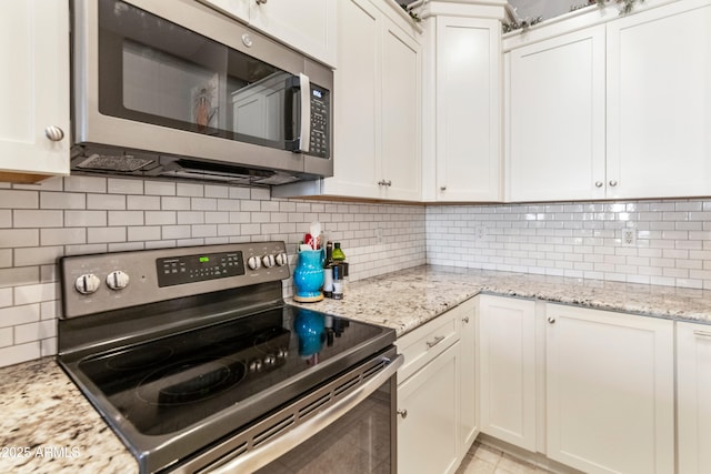 4674 E Alfalfa Dr, Gilbert, AZ 85298 - kitchen featuring white cabinets, appliances with stainless steel finishes, decorative backsplash, and light stone counters