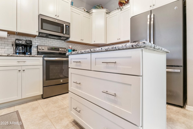 4674 E Alfalfa Dr, Gilbert, AZ 85298 - kitchen featuring light stone countertops, appliances with stainless steel finishes, backsplash, and light tile patterned flooring