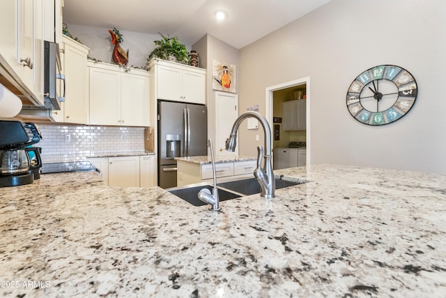 4674 E Alfalfa Dr, Gilbert, AZ 85298 - kitchen with tasteful backsplash, appliances with stainless steel finishes, light stone countertops, washer and dryer, and a sink