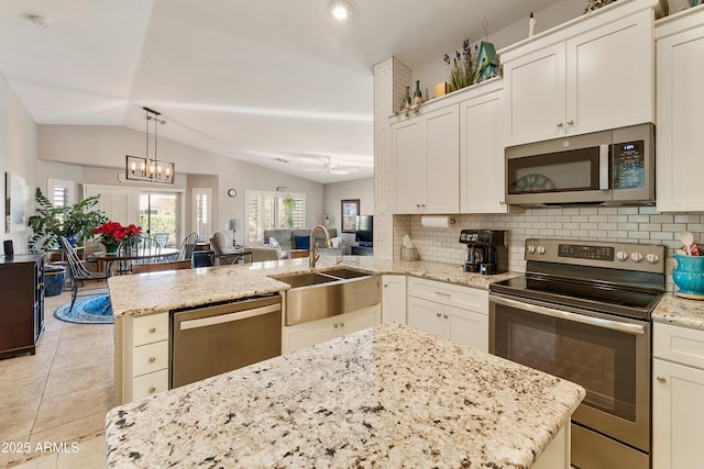 4674 E Alfalfa Dr, Gilbert, AZ 85298 - kitchen with light tile patterned floors, appliances with stainless steel finishes, open floor plan, a sink, and a peninsula