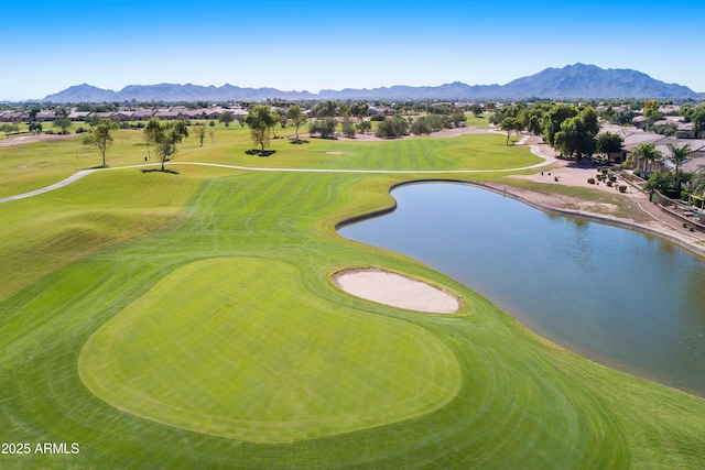 bird's eye view with view of golf course and a water and mountain view