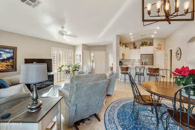 4674 E Alfalfa Dr, Gilbert, AZ 85298 - living room with arched walkways, light tile patterned floors, ceiling fan with notable chandelier, and visible vents