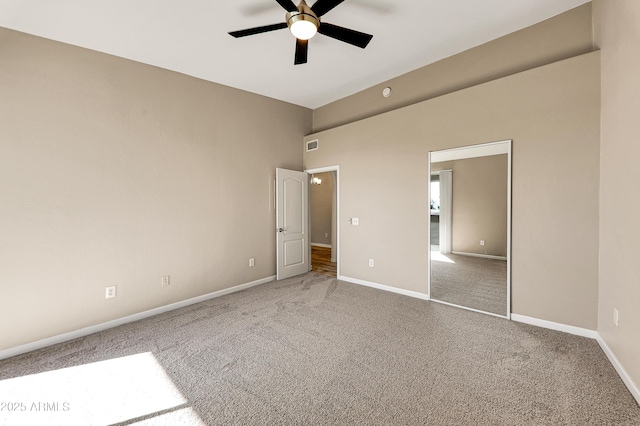 unfurnished bedroom featuring ceiling fan, a closet, and carpet floors