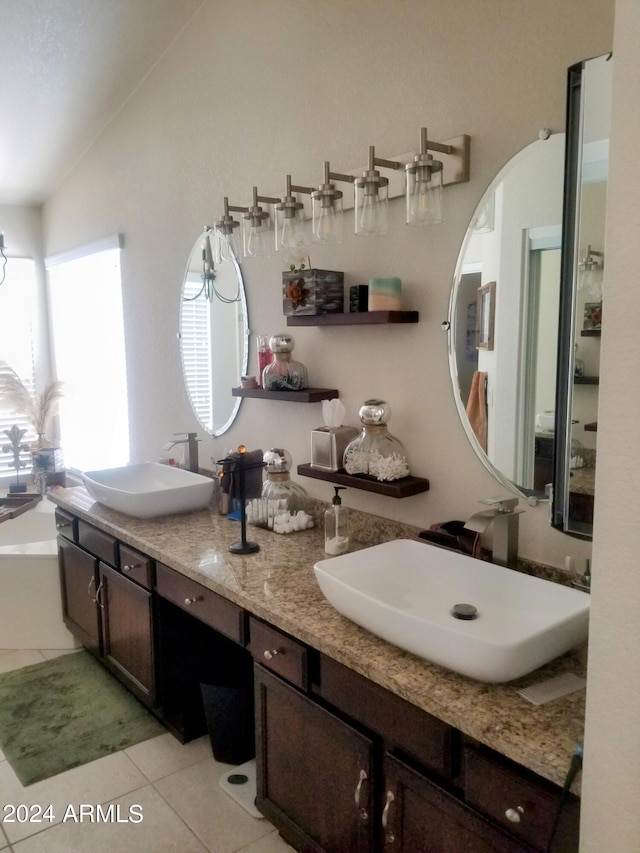 bathroom with vanity, tile patterned floors, and lofted ceiling