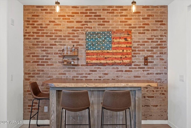 bar with baseboards and hanging light fixtures
