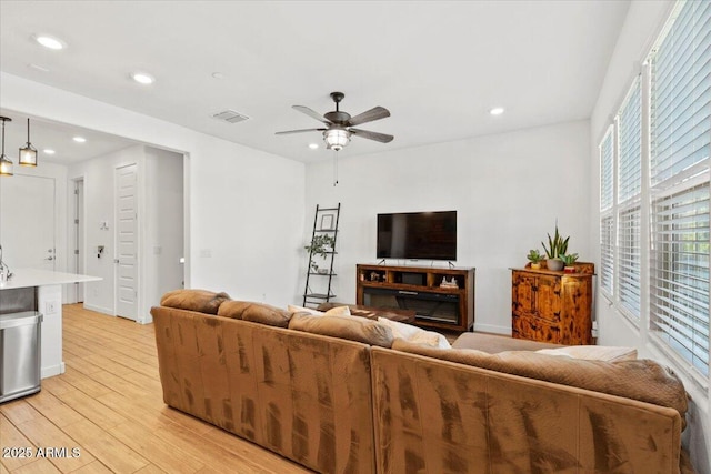 living area with visible vents, recessed lighting, and light wood-type flooring