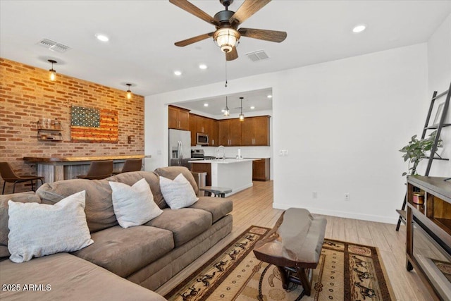 living area with visible vents, recessed lighting, ceiling fan, and light wood-type flooring