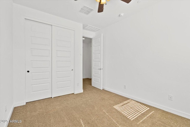 unfurnished bedroom featuring carpet floors, baseboards, visible vents, and a closet