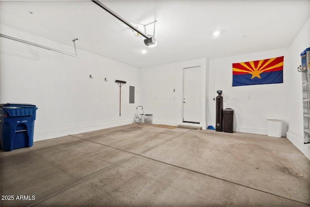 garage featuring baseboards, a garage door opener, and electric panel