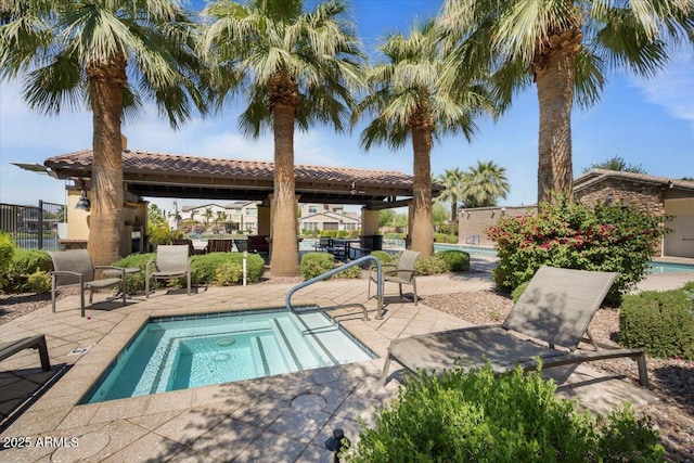 community pool featuring a gazebo, fence, and a patio area