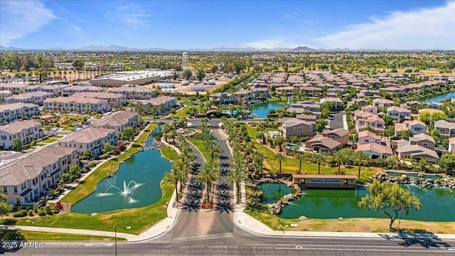 drone / aerial view with a water and mountain view and a residential view